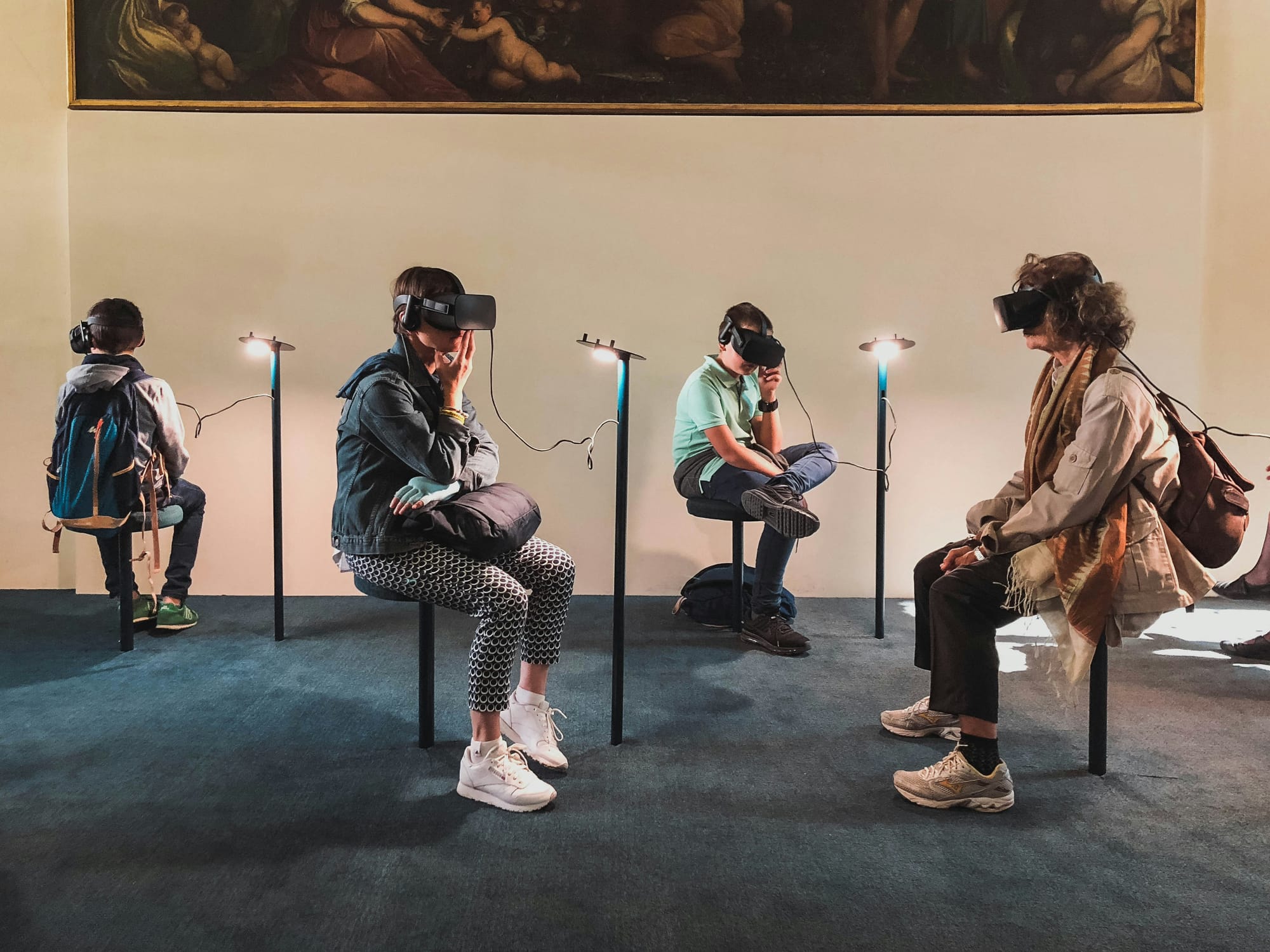 people with vr sets sitting - Virtual Reality In Healthcare