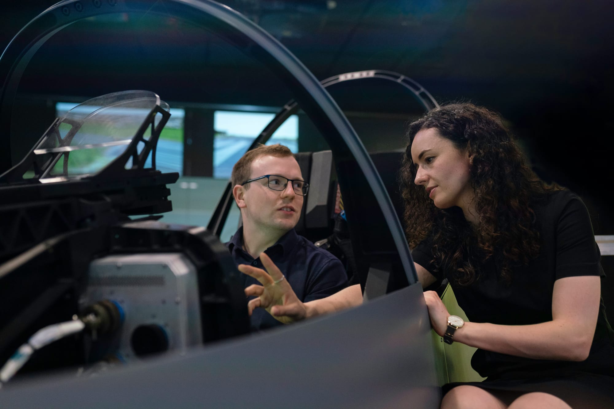 woman helping student out - vr flight simulator