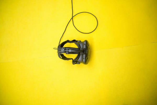 a vr headset in a yellow background - Virtual Workspace